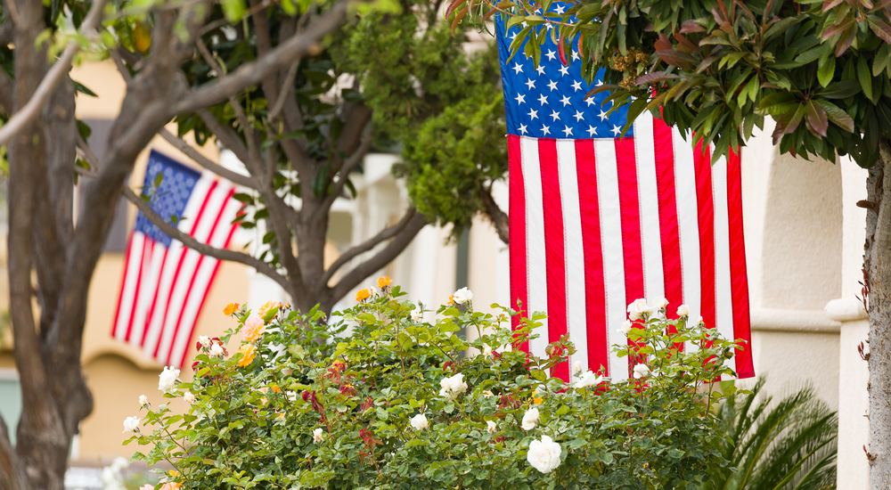 Stock photo of an American flag on a porch used in an illustrative fictional ad example