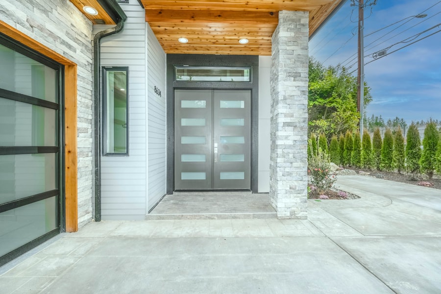 Modern Gray Entry Door With Statement Planters
